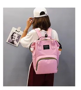 Pink diaper backpack with dual shoulder straps and top handles shown from the back view