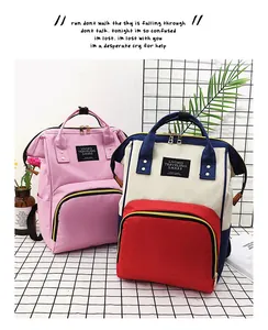 Detail of multi-functional diaper backpack showing front zipper pocket and canvas texture