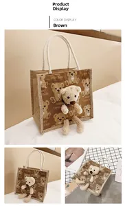 Detail of linen lunch bag with plush bear, cotton rope handles and cartoon print