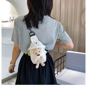 Detailed back view of a white canvas chest bag with a plush bear and black strap