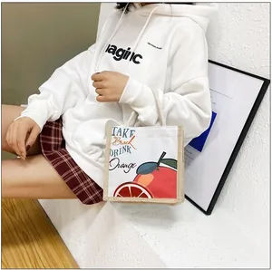 Detail of canvas tote bag with orange print and TAKE BREAK DRINK ORANGE text