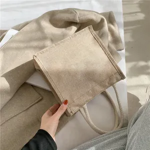 Macro view of square natural jute tote bag with woven cotton rope handles and rustic texture