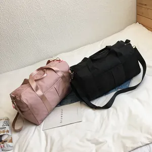 Waterproof nylon fitness bags in pink and black showing large storage capacity