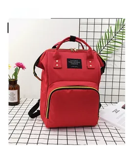 Detailed shot of red waterproof nursing backpack with large front zipper pocket and handles
