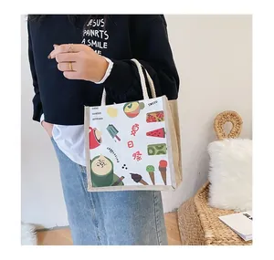Detail of canvas tote bag with Summer Festival cartoon prints and thick rope handles