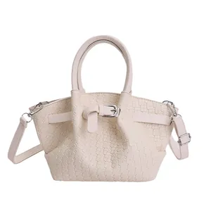 Chic beige woven bucket handbag with crossbody strap and stylish buckle detail