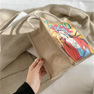 Detailed view of burlap tote bag with modern Peking Opera print and rope handles