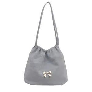 Chic light blue bucket bag with silver bow accent and drawstring closure for women