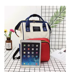 Detail view of large capacity tricolor diaper backpack showing front zipper pocket