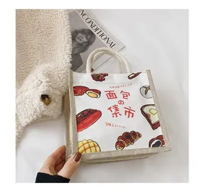 Detailed close-up of retro Japanese canvas tote bag with bread theme illustration and motifs