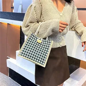 Handheld vintage houndstooth woven tote bag with large button and beige knot handles