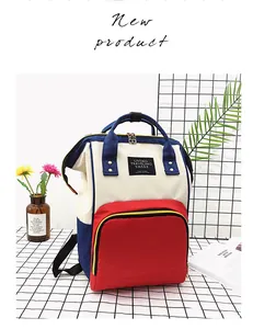 Detail view of stylish tri-color diaper bag with dual top handles and large side pockets