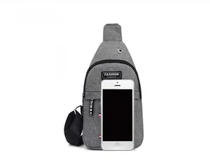 Grey oxford cloth sling bag shown with a smartphone for size and scale comparison