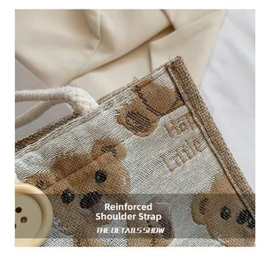 Close-up of reinforced shoulder straps and decorative button on bear linen tote bag