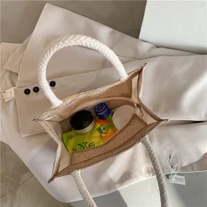 Top view of spacious interior of canvas tote bag with woven rope handles and zipper closure