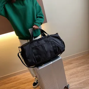 Detail of waterproof nylon gym bag with wet dry separation on luggage handle