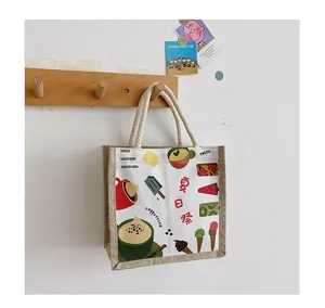 Detail of canvas tote bag with cotton rope handles and summer themed illustrations