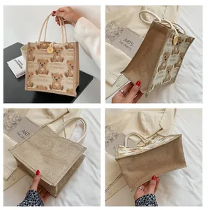 Detail view of mini linen bag showing bear prints, cotton rope handles and wood button