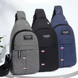 Three men's oxford fabric chest bags in gray, black, and blue with tricolor straps