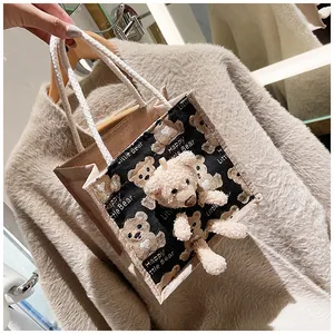 Detail of canvas tote bag featuring cute 3D plush bear and Happy Little Bear print