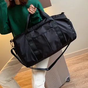 Detail view of large capacity black nylon fitness bag with reinforced handles and strap