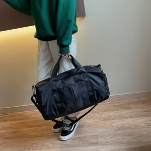 Macro shot of durable black nylon duffel bag featuring reinforced handles and wide strap