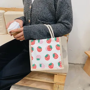 Japanese style canvas handbag featuring red strawberry prints and white cotton rope handles