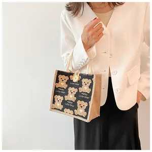 Detail of linen tote bag with cartoon bear prints and thick rope handles for women