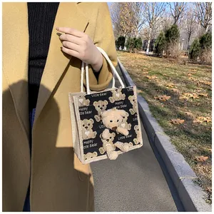 Detailed view of canvas mini tote with plush bear ornament and Little Bear print