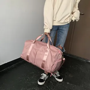 Detail of a large pink waterproof nylon fitness bag with reinforced webbing handles
