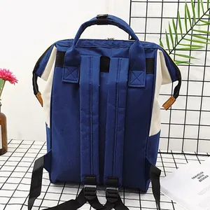 Contrast color canvas diaper backpack with blue and white design and padded straps