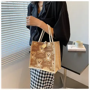 Close-up of bear pattern linen tote bag with cotton rope handles and wood button closure