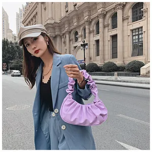 Detail of lavender pleated cloud bag with elegant leather texture in a street style setting