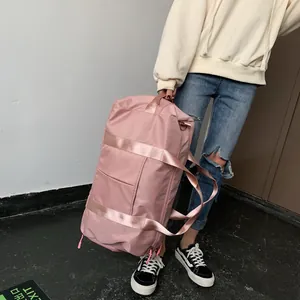 Detailed close-up of a pink waterproof nylon gym bag featuring reinforced straps and zippers
