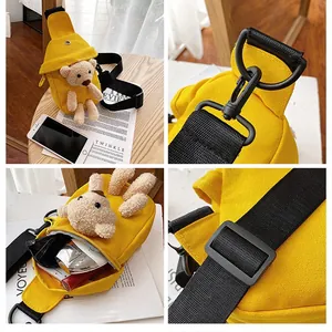 Detail view of yellow canvas chest bag with cute bear decoration and its interior space