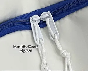 Detail of the durable two-way double-headed zipper with cords on a quilted backpack