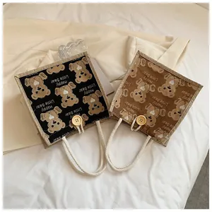 Detail of linen tote bag featuring cotton rope handles and decorative wooden button closure