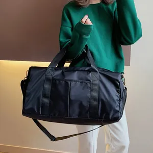 Waterproof nylon gym bag with dry-wet separation carried by model in casual style