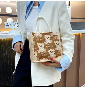 Detailed shot of linen tote bag with cartoon bear print and thick rope handle
