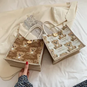 Linen tote bags with cartoon bear prints in dark brown and beige with wooden buttons