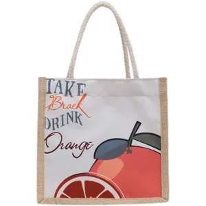 Canvas and jute tote bag with orange print and thick rope handles on white background