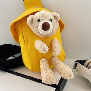 Dettaglio della borsa a tracolla in tela gialla con un simpatico orsetto di peluche 3D