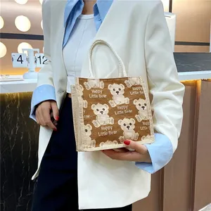 Detail of linen handbag with bear print and sturdy woven rope handle shown in a lifestyle setting