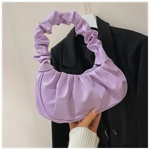 Close-up of lavender pleated cloud bag showing soft leather texture and stylish handle