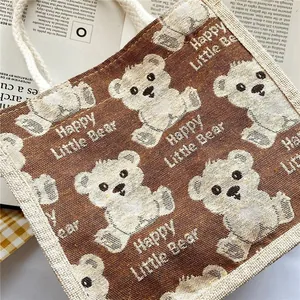 Detail of linen tote bag featuring cute white bear patterns and soft cotton rope handle