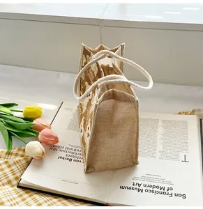 Detail of linen tote bag featuring a cute bear print and soft braided cotton rope handle