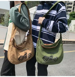 Outdoor lifestyle shot of large khaki and army green canvas crossbody bags with wide straps