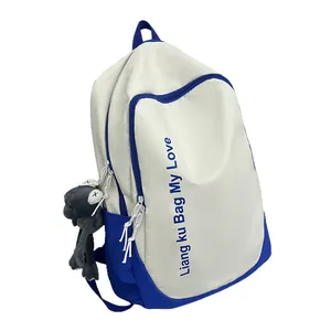 Contrast color white and blue canvas backpack with large capacity and cartoon pendant