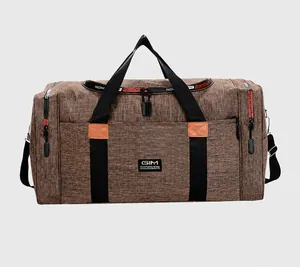 Detailed view of large travel duffel bag with brown textured fabric and sports straps