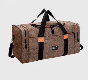 Macro detail of dark brown travel bag with orange leather tabs and durable black handles